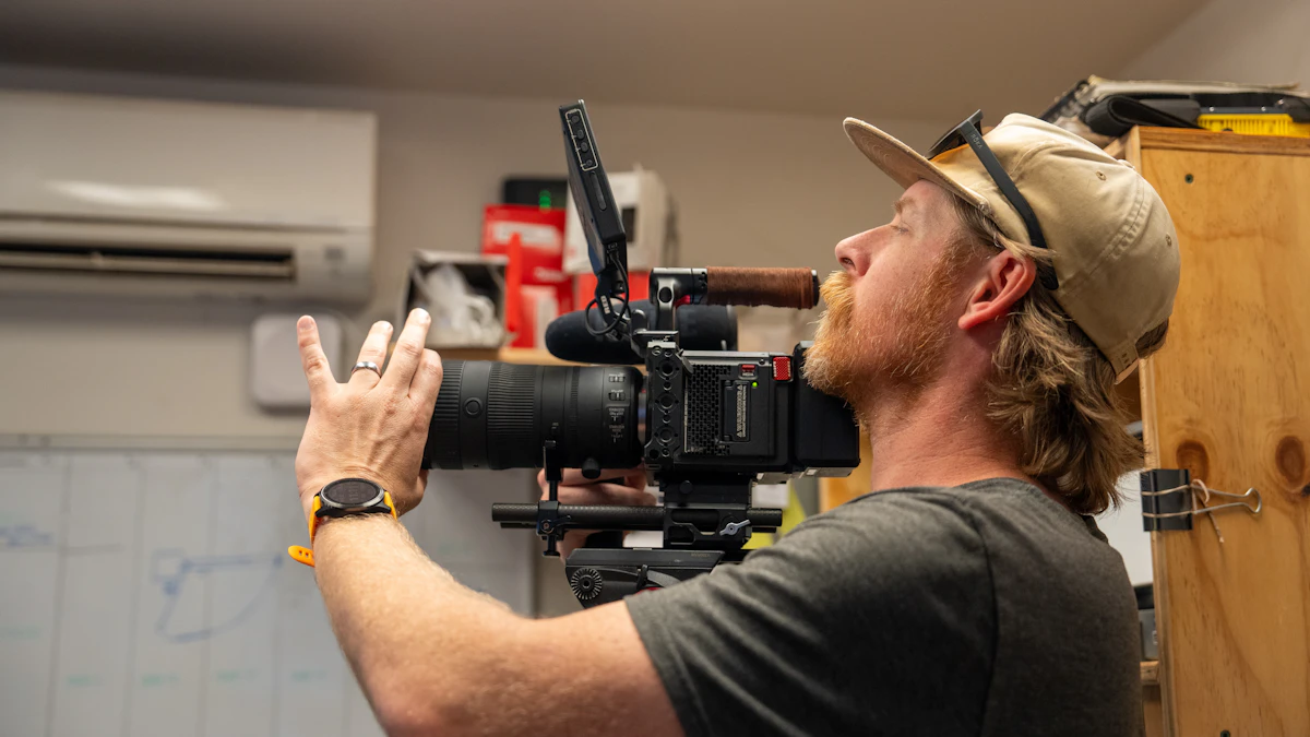 Camera operator adjusting a cinema camera during an indoor video shoot