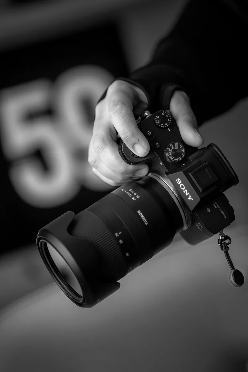 Hands holding a camera during content production