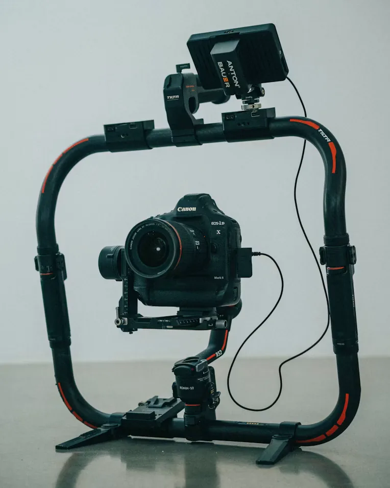 Camera on a handheld production rig with an external monitor