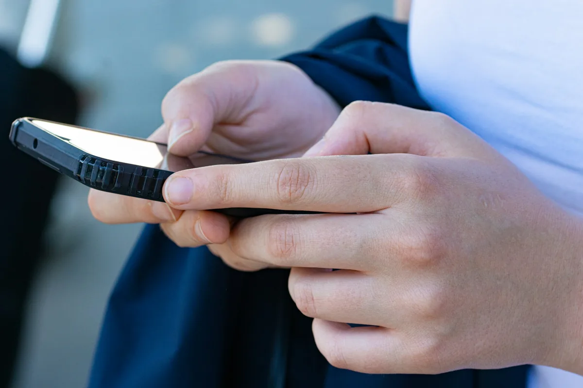 Hands using a phone during content planning