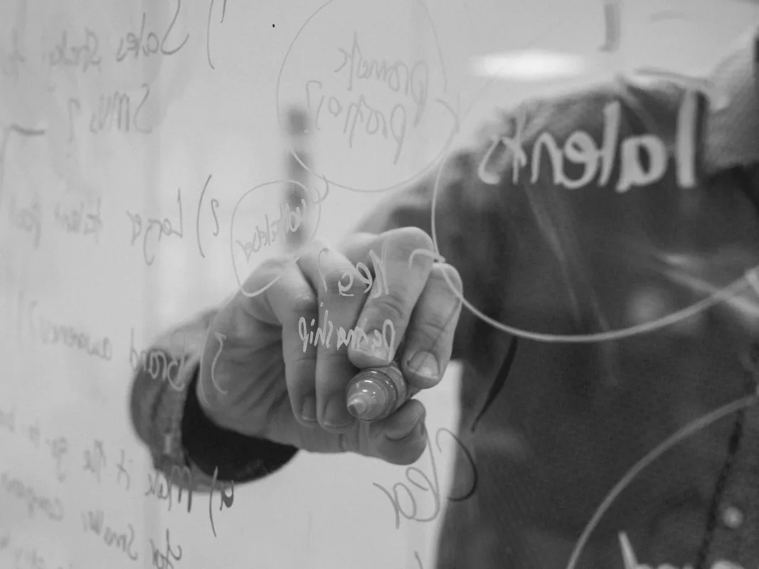 Drawing connected ideas on a glass board during planning
